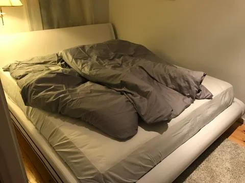 Luxury bed with grey sheets Foto stock
