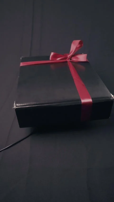 Luxury Black Gift Box With Red Ribbon Rotating Loop Stock Footage 322606977