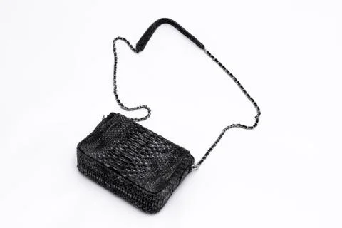 Luxury black snakeskin python leather handbag isolated on a white background. Photos