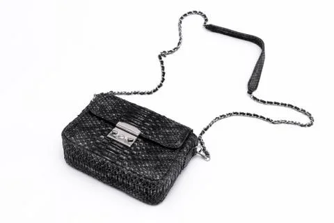 Luxury black snakeskin python leather handbag isolated on a white background. Photos