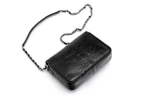 Luxury black snakeskin python leather handbag isolated on a white background. 스톡 사진