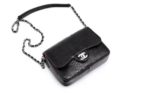 Luxury black snakeskin python leather handbag isolated on a white background. Photos