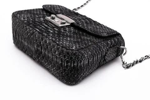 Luxury black snakeskin python leather handbag isolated on a white background. Photos