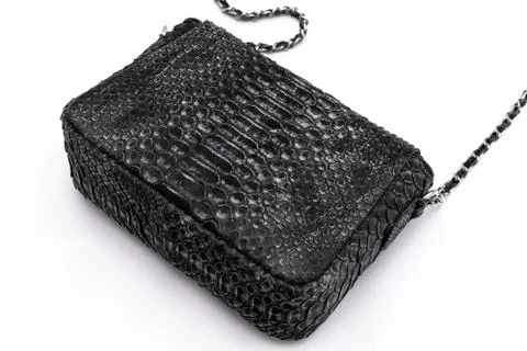 Luxury black snakeskin python leather handbag isolated on a white background. 스톡 사진