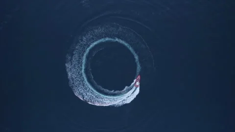 Luxury boat forms a circle of waves with... | Stock Video | Pond5