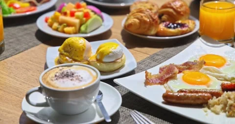 Luxury breakfast spread featuring eggs benedict coffee and pastries Stock Footage 331535123