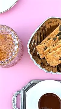 Luxury breakfast table featuring silver bowl of crispy biscuits, ornate tea cup Stock Photos