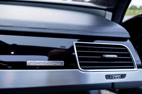 Luxury Car Interior Dashboard Close-Up With Quattro Badge and Brushed Metal.. Stock Photos
