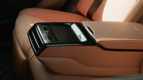 Luxury Car Rear Armrest Console Featuring Touch Screen Display Stock Footage 343369429