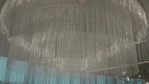 Luxury chandelier with cascading strings and soft sparkling lights Video stock 313099151