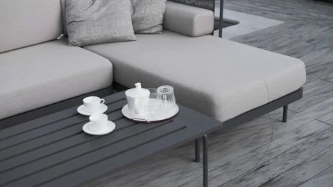 Luxury designer table with upholstered sofas for outdoor tea parties Stock Footage 220772793