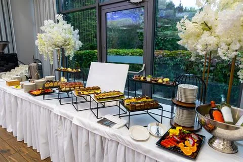 Luxury dessert buffet table setup with wine and fruit. Elegant buffet Stock Photos