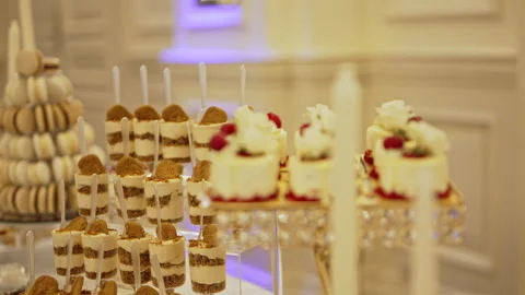 Luxury Dessert Table with Mini Cake Shooters and Macaron Tower Stock Footage 327774218