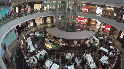 Luxury Dining in an Atrium Restaurant at the Mall inside Marina Bay Sands Stock Footage 72559581