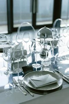 Luxury dining table with elegant glassware and modern place settings Stock Photos