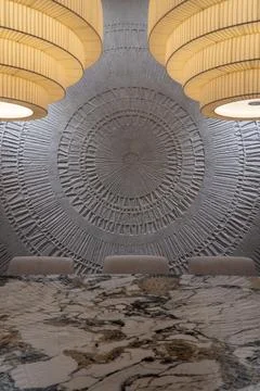 Luxury dining table with marble surface and sculptural pendant lights Stockfoto's