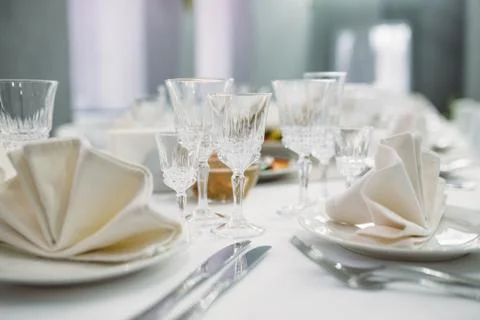 Luxury dinner set arranged on a table with vintage cream lace tablecloth and  Stock Photos