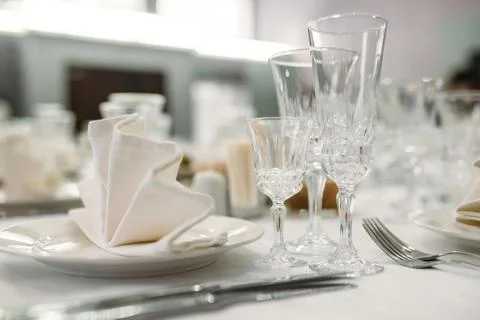 Luxury dinner set arranged on a table with vintage cream lace tablecloth and  Stock Photos