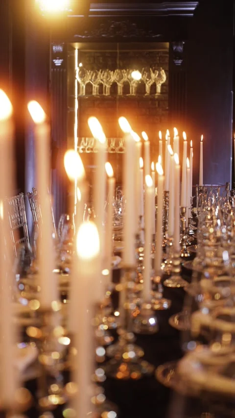 Luxury dinner table decorated with many tall white candles in elegant holders Stock Footage 318930607