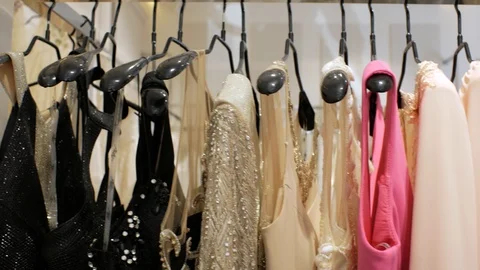 Luxury evening dresses hang on hangers in the store. wedding dresses. 4k Stock Footage