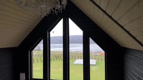 Luxury A-Frame Cabin Interior with Panoramic Triangular Window and Chandelier Stock Footage 320497806