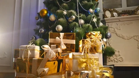 Luxury gift boxes under Christmas tree, New Year home decorations, golden Stock Footage 70963341