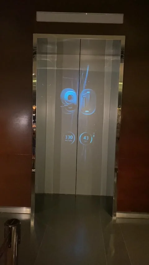 Luxury glass elevator doors with digital floor display inside iconic hotel Stock Footage 335258473