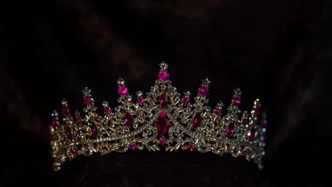 Luxury Golden Crown with Ruby Gemstones on Black Background Stock Footage 332503847