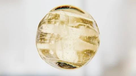 Luxury golden serum liquid bubble. Beauty cosmetics macro 3D abstract background Video stock 337100733