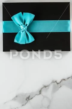 Luxury holiday gifts with emerald silk ribbon and bow on marble background Stock Photos