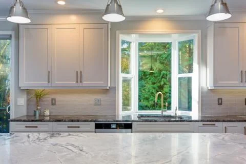 Luxury home interior boasts amazing white kitchen with custom white shaker ca Stock Photos