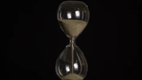 Luxury hourglass with gold sand on a black background wide shot 4k Stock Footage