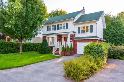 Luxury house with garage door, big tree and nice spring blossom Stock Photos