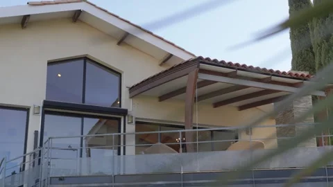 Luxury house with large windows and a wide balcony with sun shade 库存影片 335347577