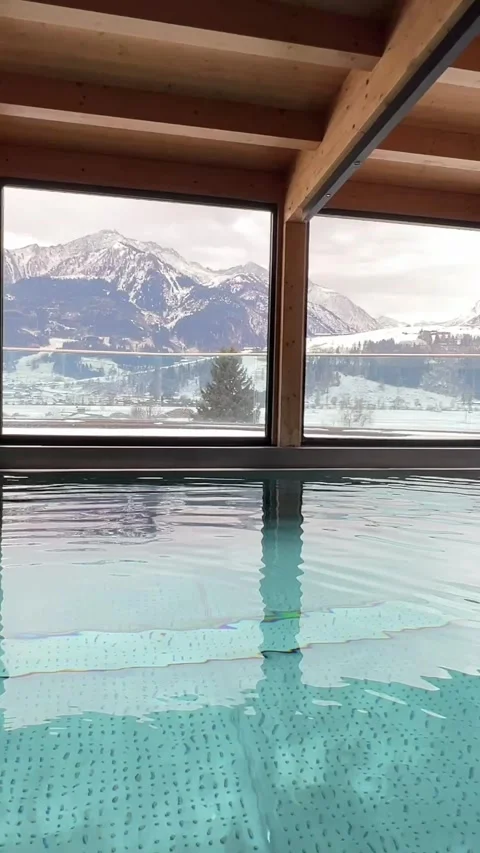 Luxury Indoor Pool with Panoramic Window and Mountain View Stock Footage 324572932