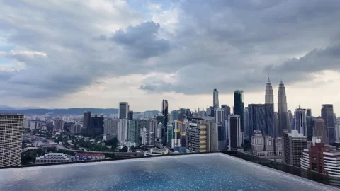 Luxury infinity pool condo Kuala Lumpur Malaysia skyline urban city Petronas Stock Footage 334810731