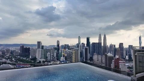 Luxury infinity pool condo Kuala Lumpur Malaysia skyline urban city Petronas Stock Footage 334810836