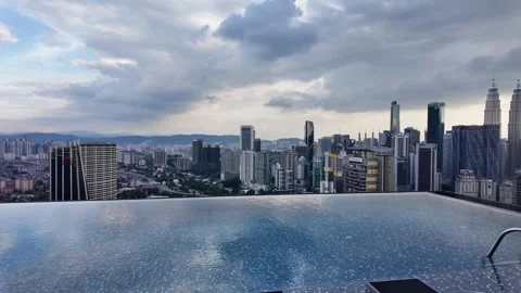 Luxury infinity pool condo Kuala Lumpur Malaysia skyline urban city Petronas Stock Footage 334810851