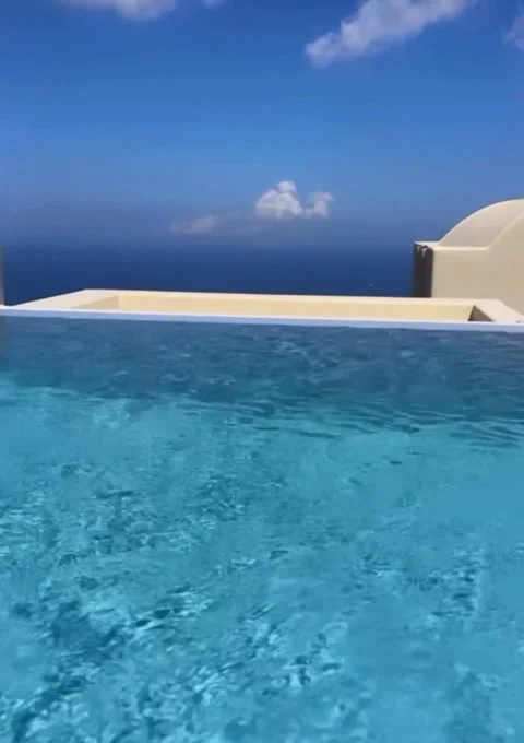 Luxury Infinity Pool with Crystal Clear Blue Water Overlooking the Sea Stock Footage 336924745