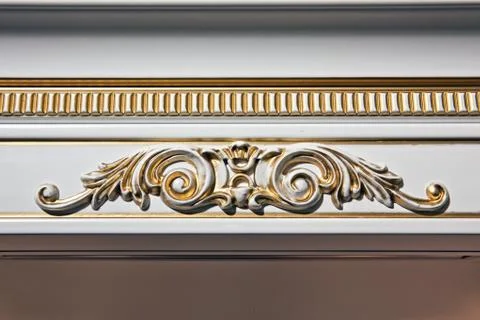 Luxury interior. Stucco elements on light wall. White patterned. Mouldings el Stock Photos