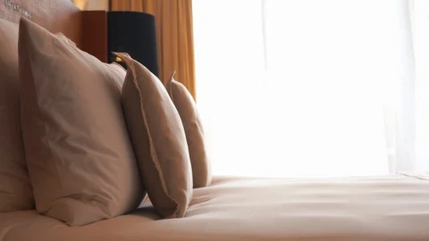 Luxury king size bed in a hotel resort sits waiting for its guests Stock Footage
