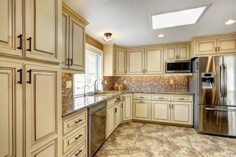 Luxury kitchen interior in light beige color with mosaic tile back splash tri Stock Photos