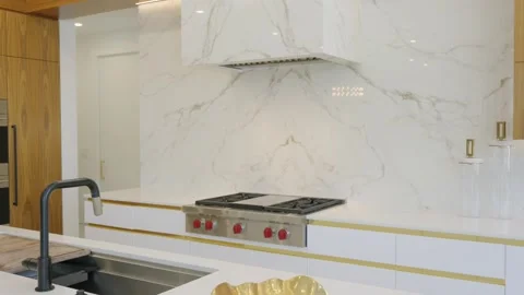 Luxury kitchen interior in white coloured tiles and wooden shelves around bulit Stock Footage 280444756