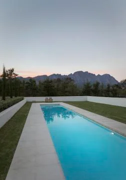 Luxury lap pool with view of mountains at dusk Stock Photos