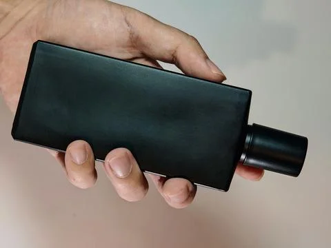 Luxury Matte Black Rectangular Perfume Bottle with Cylindrical Cap Stock Photos