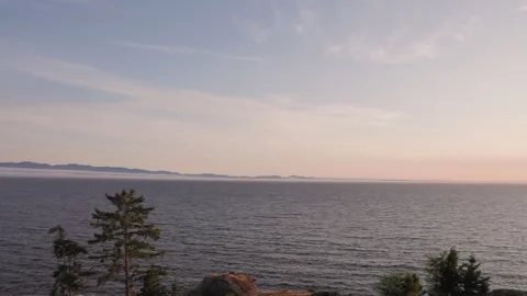 Luxury ocean front condos overlooking beautiful ocean sunset vista, Sooke BC Stock Footage 246610347