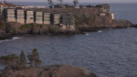 Luxury ocean front condos overlooking beautiful ocean sunset vista, Sooke BC Stock Footage 248210741