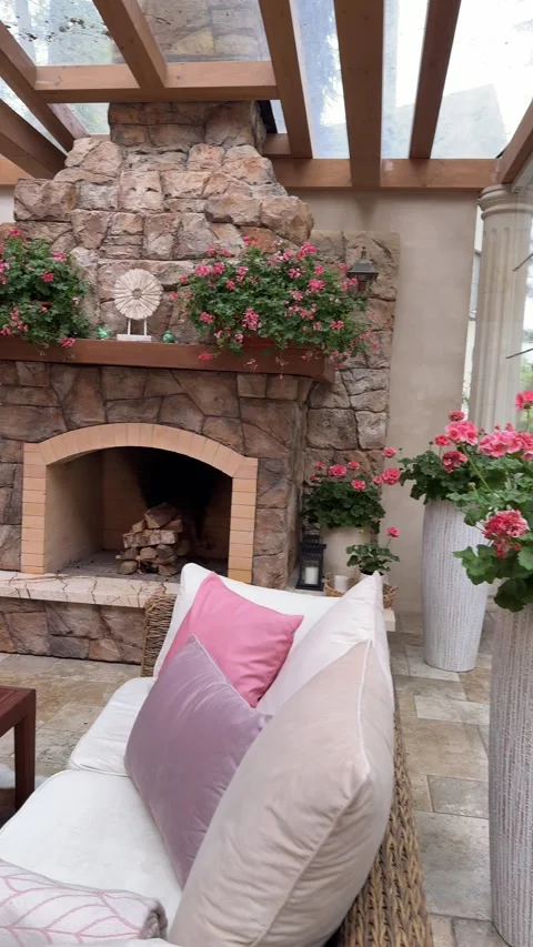 Luxury Outdoor Seating Area With Wicker Sofas and Fireplace Decor Stock Footage 334886529