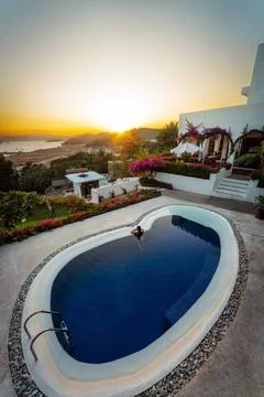 Luxury Pool Overlooking  the Ocean during Sunset Stock Photos
