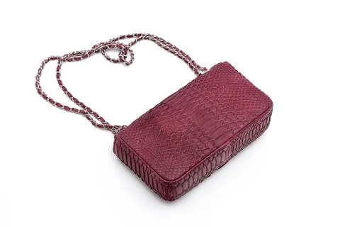 Luxury red snakeskin python leather handbag isolated on a white background. 写真素材